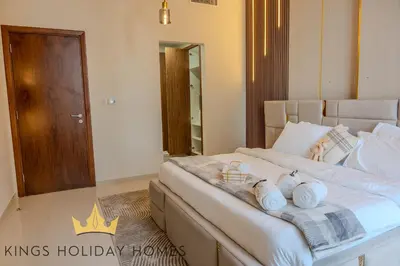 a bedroom with a large bed with towels on it at Royal Suites Dunya Tower Burj Khalifa ST in Dubai