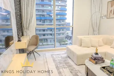 a living room with a white couch and a large window at Royal Suites Dunya Tower Burj Khalifa ST in Dubai