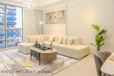a living room with a white couch and a coffee table at Royal Suites Dunya Tower Burj Khalifa ST in Dubai