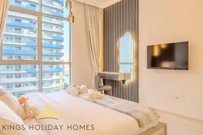 a bedroom with a bed and a large window at Royal Suites Dunya Tower Burj Khalifa ST in Dubai