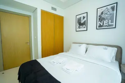 a bedroom with a bed with two towels on it at High-Floor 2BR - Aykon City 2BR in Business Bay in Dubai
