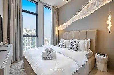 a bedroom with a large bed with a large window at Binghatti Gardenia 1BR - Near Parks and Mall JVC in Dubai