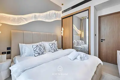 a bedroom with two beds and a mirror at Binghatti Gardenia 1BR - Near Parks and Mall JVC in Dubai
