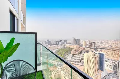 a balcony of a building with a view of a city at Binghatti Gardenia 1BR - Near Parks and Mall JVC in Dubai