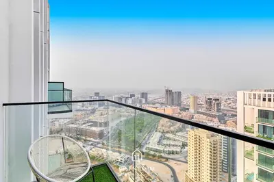 a view from the top of a building with two chairs at High Floor 1BR - Near Parks and Mall - JVC in Dubai