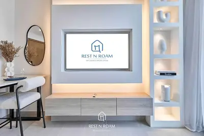 a dining room with a dresser and a mirror at High Floor 1BR - Near Parks and Mall - JVC in Dubai
