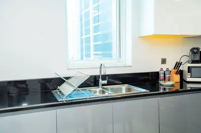 a kitchen counter with a sink and a window at Charming Studio and Perfect Stay with Gym and Pool in Dubai