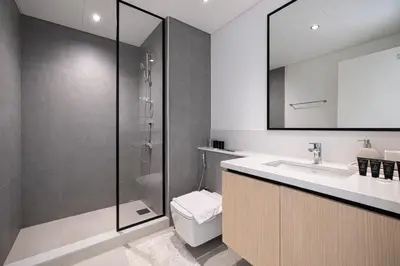 a bathroom with a toilet and a sink and a shower at Exceptional 2 Bedroom Apartment! High Floor! Amazing Rooftop! Burj Crown by Emaar in Dubai