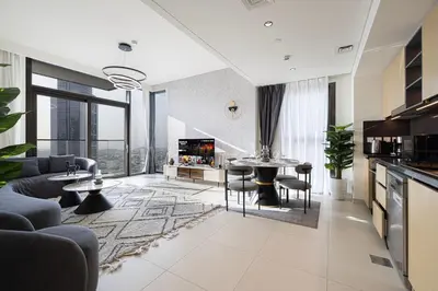 a living room with a couch and a table and chairs at Exceptional 2 Bedroom Apartment! High Floor! Amazing Rooftop! Burj Crown by Emaar in Dubai