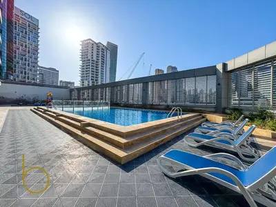 a swimming pool on the roof of a building with lounge chairs at Bookable - Penthouse 5,000sqft by Downtown Dubai in Dubai