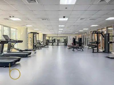a gym with rows of treadmills and machines at Bookable - Penthouse 5,000sqft by Downtown Dubai in Dubai