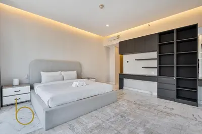 a bedroom with a large bed and a black cabinet at Bookable - Penthouse 5,000sqft by Downtown Dubai in Dubai