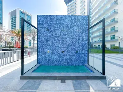 a blue shower in the middle of a building at Urban Escape Studio l Pool, Gym & Stylish Living in Dubai