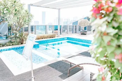a swimming pool on the roof of a building at Urban 1BR Stay, Walk to Downtown & Canal in Dubai