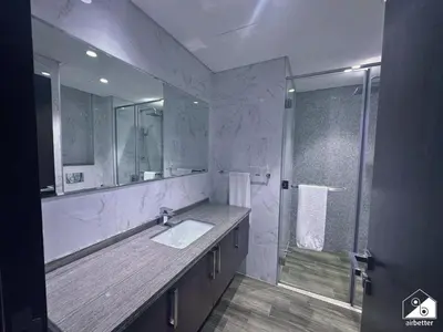 a bathroom with a sink and a shower at Urban 1BR Stay, Walk to Downtown & Canal in Dubai