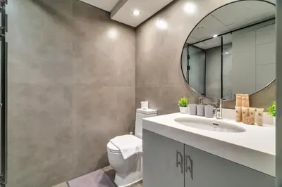 a bathroom with a sink and a mirror at Exec 1Bed with Balcony&Pool, 10mins to Downtown in Dubai