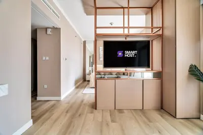 a living room with a tv on a shelf at Exec 1Bed with Balcony&Pool, 10mins to Downtown in Dubai