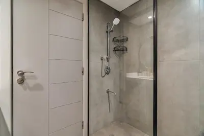 a shower with a glass door in a bathroom at Exec 1Bed with Balcony&Pool, 10mins to Downtown in Dubai