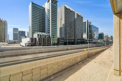 a city skyline with tall buildings and a highway at Exec 1Bed with Balcony&Pool, 10mins to Downtown in Dubai
