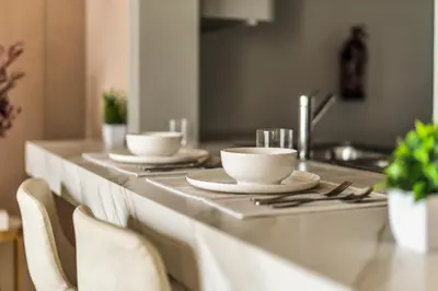 a table with two cups and plates on it at Exec 1Bed with Balcony&Pool, 10mins to Downtown in Dubai