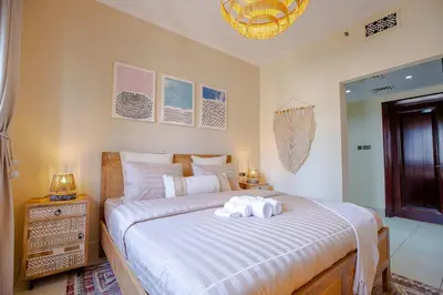 a bedroom with a bed with two towels on it at Oasis in the heart of Downtown in Dubai