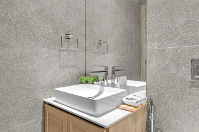 a bathroom with a white sink and a mirror at Waves - Modern JVC Studio with Balcony in Dubai