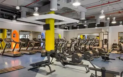 a gym with rows of treadmills and ellipticals at JBR 3BR Palm Jumeirah & Sea Views, Pool & Gym Access in Dubai
