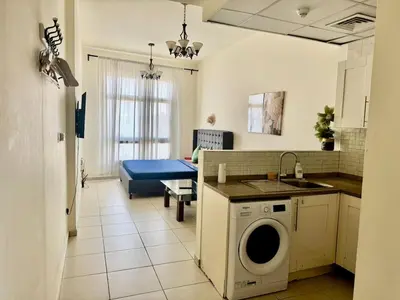 a kitchen with a washing machine in a room at Not far from metro and WTC in Dubai