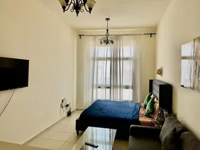 a living room with a bed and a couch at Not far from metro and WTC in Dubai