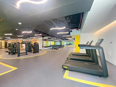 a gym with a treadmill and treadles in a room at Modern 3BR with City Views and a Spacious Layout in Dubai