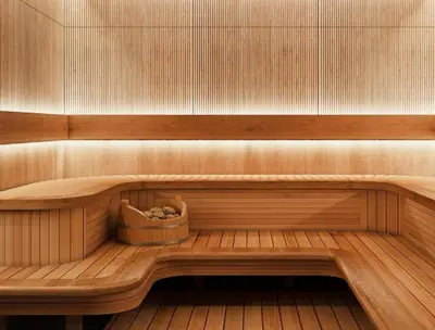 a sauna with a wooden bench with a basket in it at Modern 3BR with City Views and a Spacious Layout in Dubai
