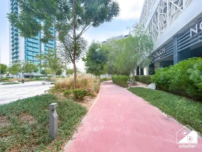 a red path in front of a building at High-End Studio l Pool & Gym Included in Dubai