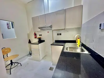 a kitchen with a sink and a counter top at Karama Palace Home in Dubai