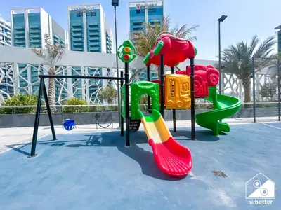 a playground with a slide at Your Fav Studio Getaway l Pool, Gym & Parking! in Dubai
