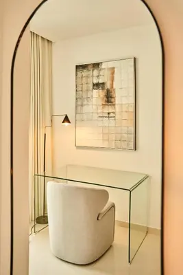 a room with a glass table and a chair at Luxury 58th Floor Seaview 2BR - Paramount Midtown - 6 Guests - 64F Pool Access & Burj View in Dubai