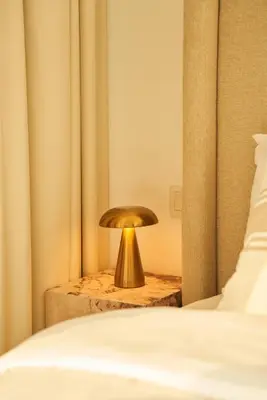 a gold lamp on a table next to a bed at Luxury 58th Floor Seaview 2BR - Paramount Midtown - 6 Guests - 64F Pool Access & Burj View in Dubai