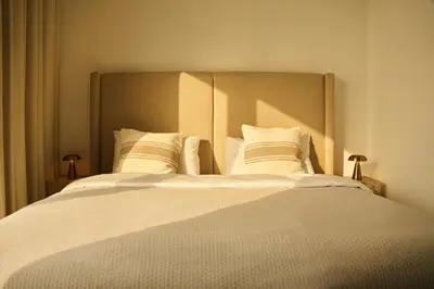 a bedroom with a large bed with white sheets and pillows at Luxury 58th Floor Seaview 2BR - Paramount Midtown - 6 Guests - 64F Pool Access & Burj View in Dubai