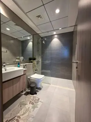 a bathroom with a toilet and a sink and a shower at Hills Parkhouse - Pool Gym Parks Mall and Burj Khalifa View in Dubai