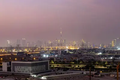 a city skyline at night with buildings and lights at Hills Parkhouse - Pool Gym Parks Mall and Burj Khalifa View in Dubai