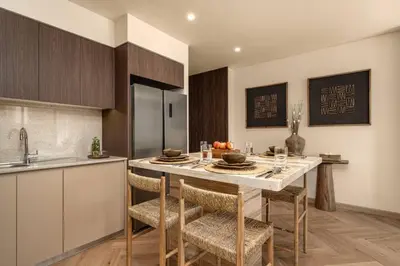 a kitchen with a table and chairs in a kitchen at Seraya Residences at Burj Royale in Dubai