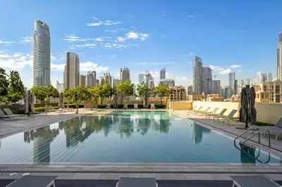 a swimming pool with a city skyline in the background at Seraya Residences at Burj Royale in Dubai