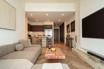 a living room with a couch and a flat screen tv at Seraya Residences at Burj Royale in Dubai