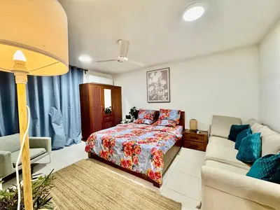 a bedroom with a bed and a couch at Spacious & cozy home 2-Bedroom in Dubai