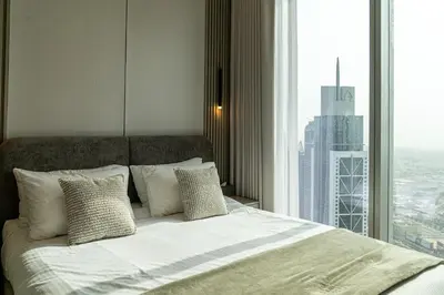 a bedroom with a bed with a large window at Serenity Suite Stylish 2BR Pool & Fitness Perks in Dubai