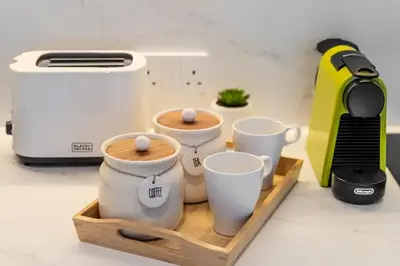 a tray with three coffee cups on a kitchen counter at Cozy Marina Studio, Canal View with a Balcony in Dubai