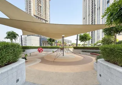 a sculpture in a park with tall buildings at Luxurious 1BR Apartment in Harbour Gate in Dubai