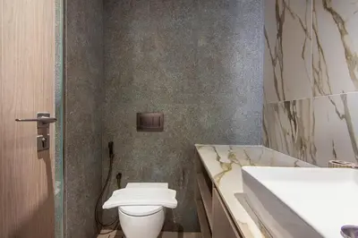 a bathroom with a toilet and a sink at Brand New Studio with Pool View in The Grove by Iman, Dubai Hills in Dubai