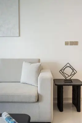 a living room with a couch and a table at Airstay - Minimalist 1BR - EMAAR Beachfront - Monthly Offer Available in Dubai