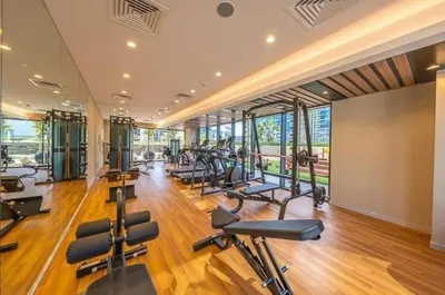 a gym with a lot of exercise equipment in a building at Facing the Dubai Water Canal 1BR, Minutes from Metro with Easy Downtown Access, Zada Tower, Business Bay by Deluxe Holiday Homes in Dubai
