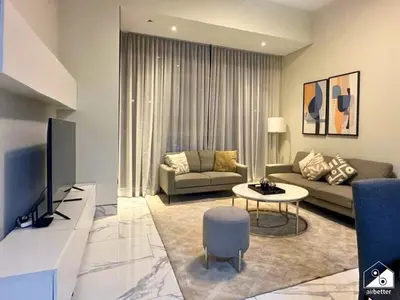 a living room with a couch and a table at Chic 1BR in Business Bay l Pool, Gym & Sauna in Dubai